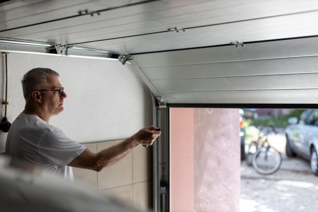 A man using a remote to open an automatic garage door in Seminole County, FL