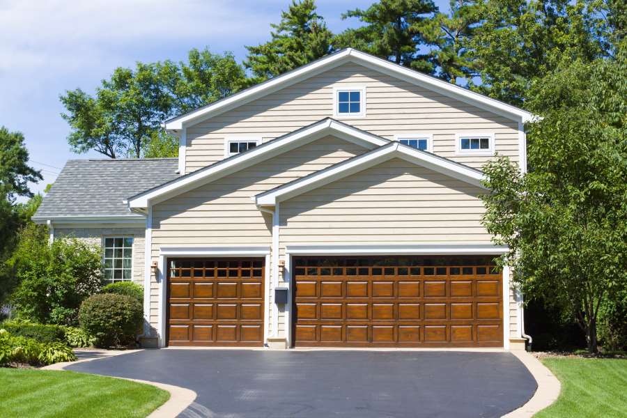 House with two wooden double garage doors in Seminole County, FL