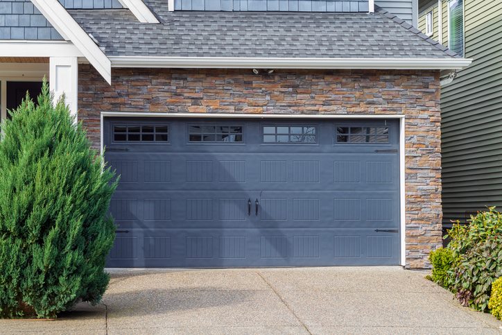 Classic blue garage door with decorative windows in Orlando, FL