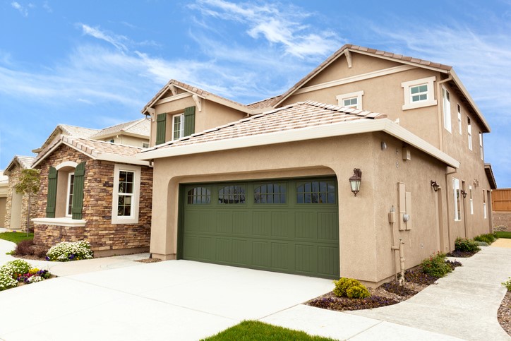 Green garage door with windows and stone accents on the house in Orlando, FL