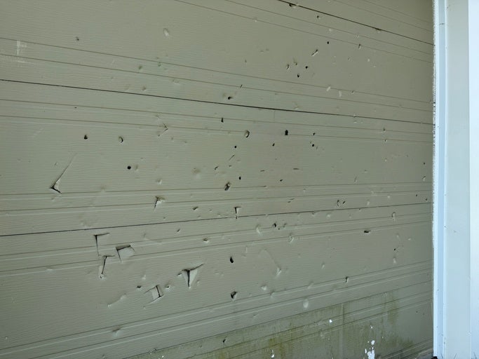 Garage door panels showing dents from storm damage in Orlando & Central FL