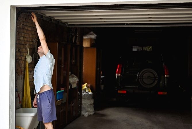 Man inspecting an open garage door in Orlando & Central FL